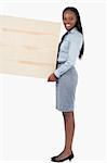 Portrait of a businesswoman holding a panel against a white background