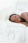 Portrait of a young woman sleeping in her bedroom