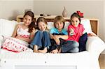 Young Children Watching Television at Home