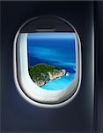 Approaching solitaire paradise island holiday destination, jet plane window sky view