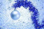 christmas silver bauble on blue winter ice background