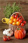 Fresh kitchen garden vegetables in a wicker basket.