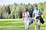 Young couple with clubs on the golf course