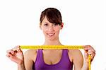 Athletic young woman holding a measuring tape - Healthy body concept