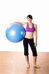 Beautiful young and athletic woman making exercises on a fitness ball