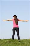 Teenage Girl Standing In Summer Meadow