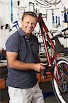 Owner of cycle shop in workshop
