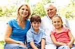 Grandparents And Grandchildren Enjoying Day In Park