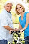 Senior Couple On Cycle Ride In Park