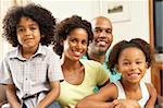 Family Relaxing At Home On Sofa