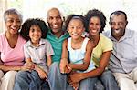 Extended Family Relaxing On Sofa At Home Together