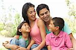 Portrait Of Young Family In Park