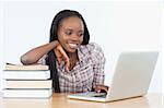 Student woman working with a laptop against a white background