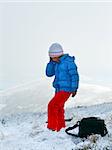 Girl talk by cellphone on autumn  mountain plateau first winter snow