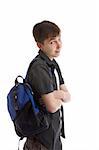 Teen student with backpack slung over shoulder.   He has his arms casually folded and is looking over and smiling.