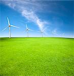 Wind turbines in an green field with cloud background