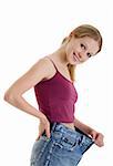 pretty girl in jeans lost weight on a white background