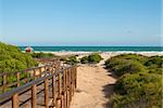 Footbridge leading down to a idyllic Mediterranean beach