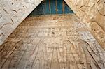 Egyptian hieroglyphic carvings on a wall at the temple of Medinat Habu in Luxor