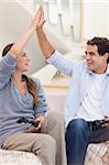 Portrait of a cheerful couple playing video games in their living room