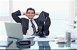 Happy businessman relaxing in his office