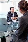 Portrait of a manager interviewing a female applicant in his office
