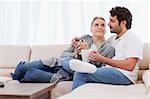 Couple having a cup of coffee in their living room