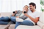 Couple drinking a glass of  red wine in their living room