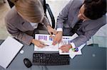 Serisous business team studying statistics in a meeting room