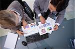 Business team looking at statistics in a meeting room