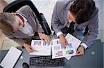 Young business team looking at statistics in a meeting room