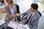 Business people agreeing on a deal in a meeting room