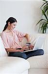 Portrait of a woman shopping online in her living room