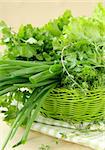 fresh green grass parsley dill onion herbs mix in a wicker basket