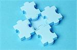 Close up of jigsaw puzzle blocks arranged on blue background