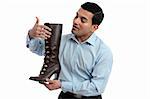 A store salesman showing a women's leather lace up boot.  White background.