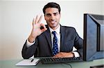 Businessman showing everything is perfect in his office