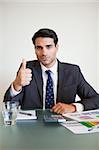 Portrait of a businessman with the thumb up in his office