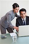 Portrait of a focused business team working with a laptop in an office