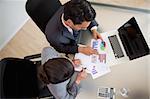 Sales persons studying statistics in an office