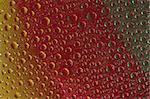Abstract water drops over yellow, red and green background