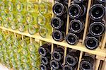 Red and White wine bottles in wooden rack