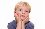 Portrait of dreaming young boy on white background