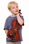 Portrait of a young boy holding his violin