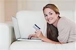 Woman shopping online in her living room