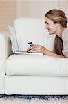 Portrait of a young woman shopping online in her living room