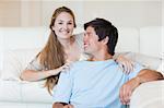 Charming couple watching television in their living room