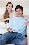 Portrait of a couple watching television in their living room