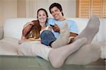 Relaxed young couple watching television in their living room
