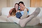 Relaxed lovely couple watching television in their living room